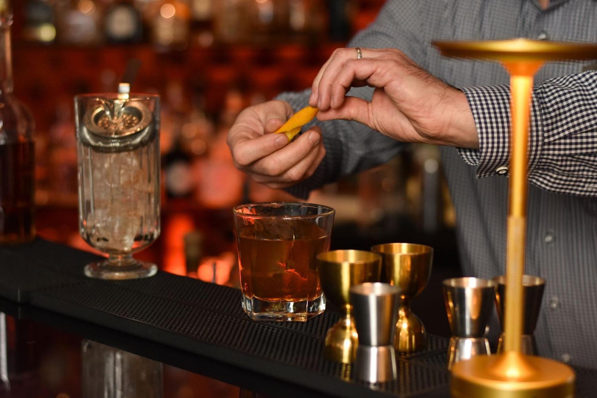 Cologne Marriott Hotel Екстериор снимка A bartender adding a lemon twist to a cocktail